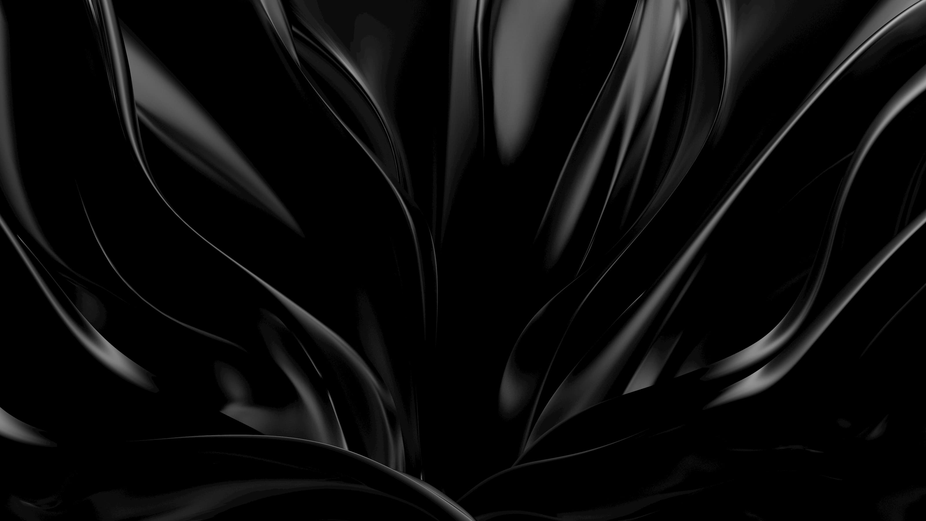 Smooth, flowing black satin fabric with glossy highlights and deep folds.