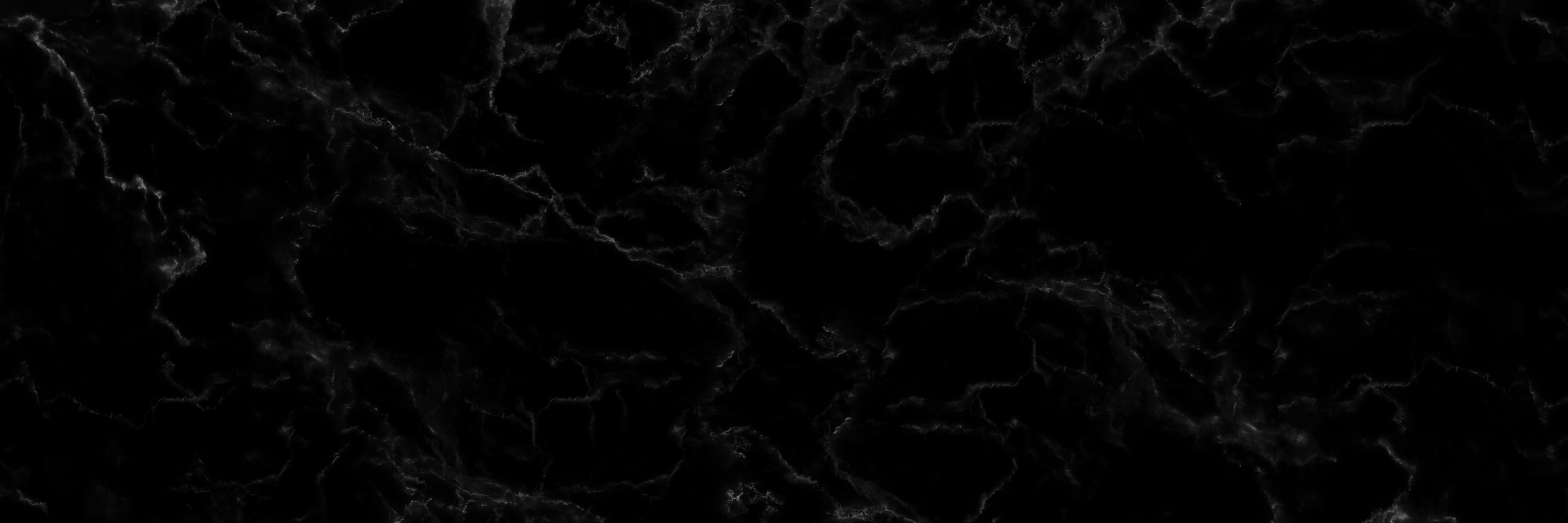 Black marble texture with subtle white veins creating an elegant natural pattern.