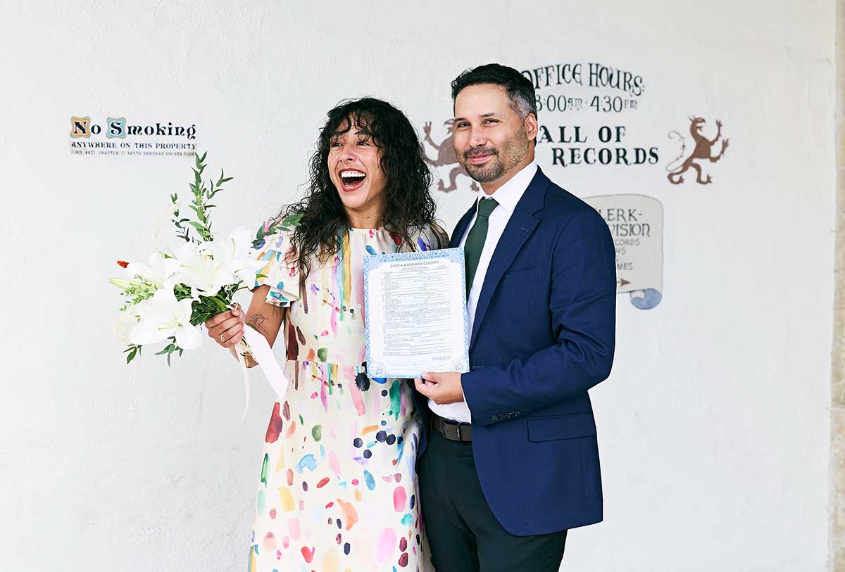 Couple in a moment of shock after getting their marriage license at the Santa Barbara hall of records.