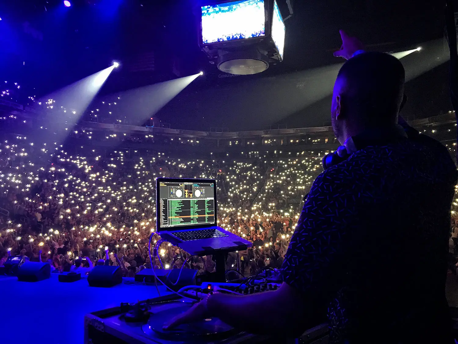 Dean Michaels DJing in a packed arena