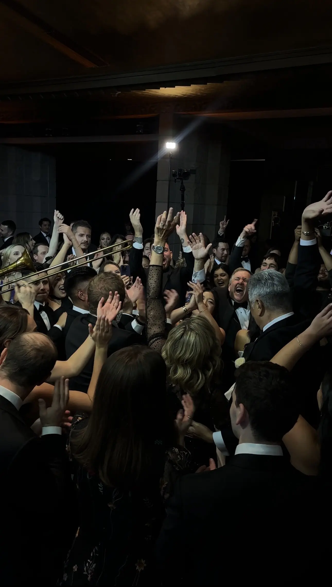 Packed wedding dance floor with hands in the air