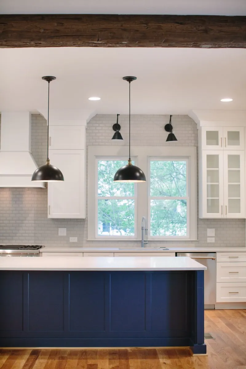 Designer kitchen with navy island and exposed beam