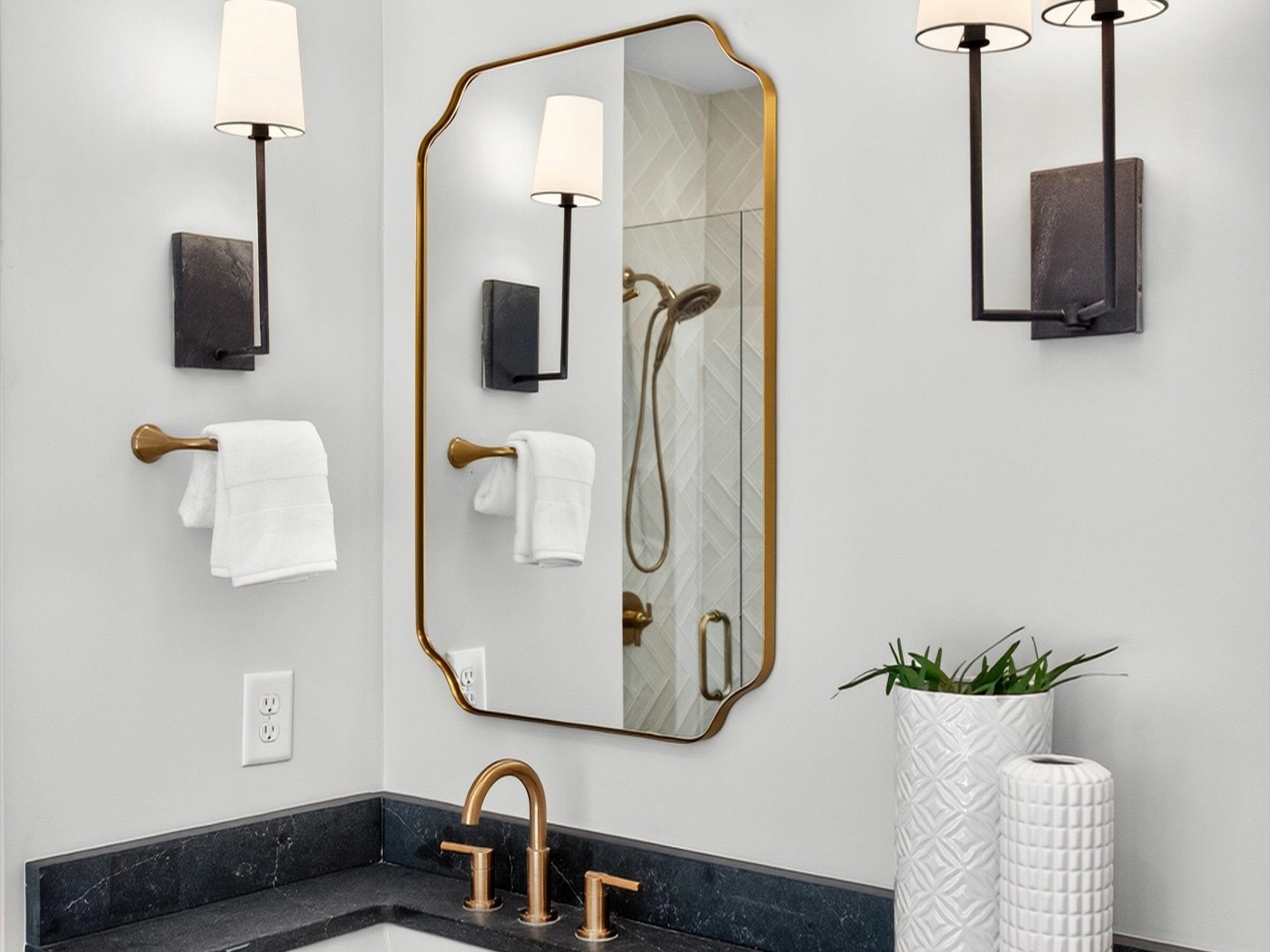 Brass fixtures and soapstone counters in a Charlotte infill home bathroom