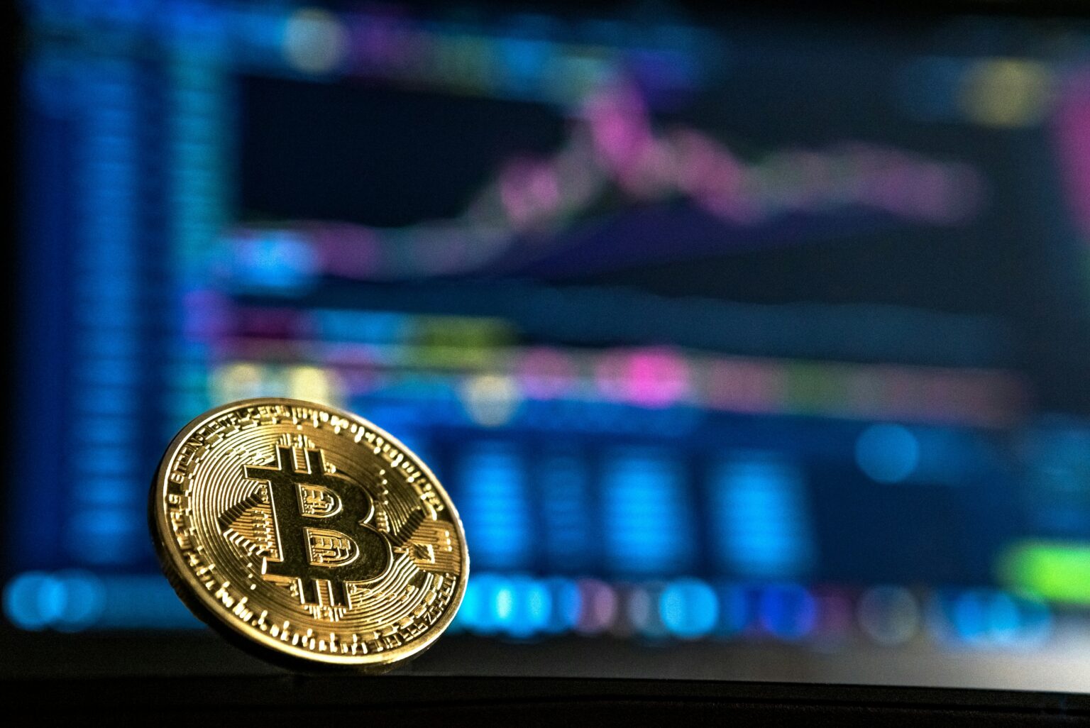 Bitcoin coin with digital background behind it