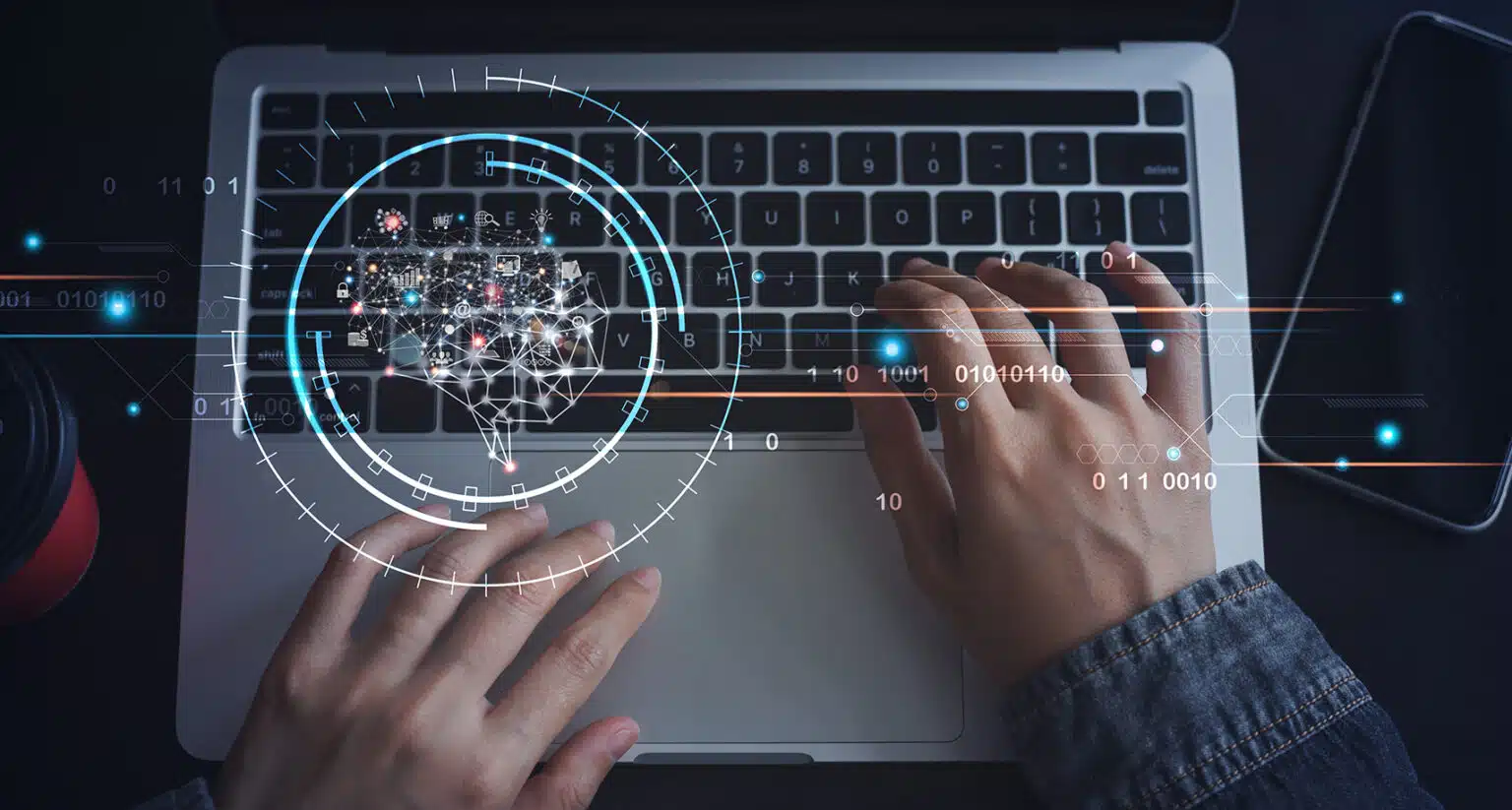 Imagem de uma pessoa usando um laptop com gráficos digitais sobrepostos