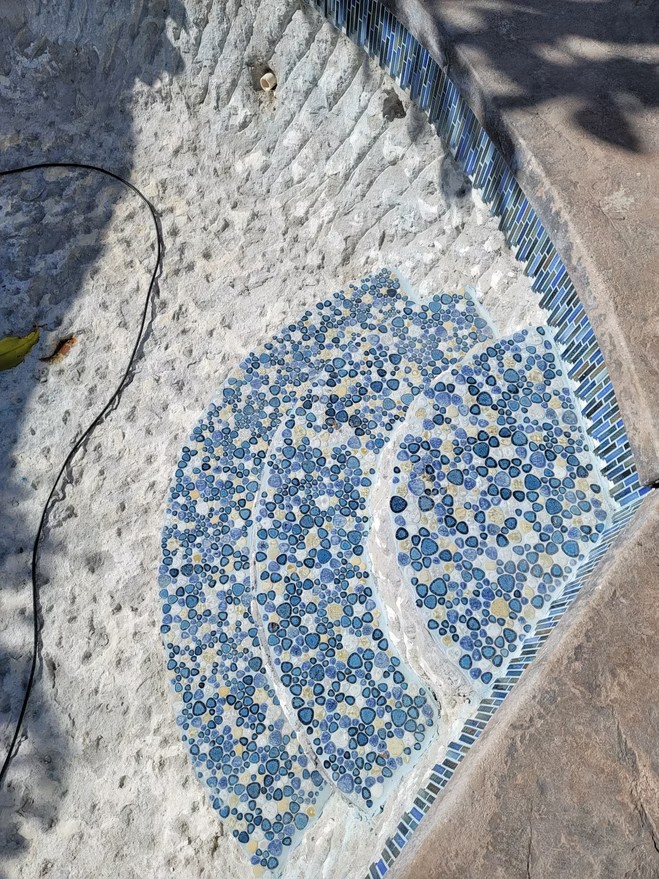 Pool steps with blue mosaic tile