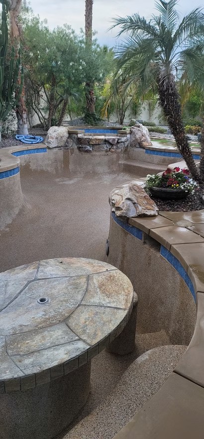 Custom pool with natural stone features and built-in seating