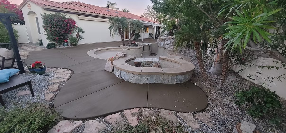 Backyard patio with a curved stone fire pit