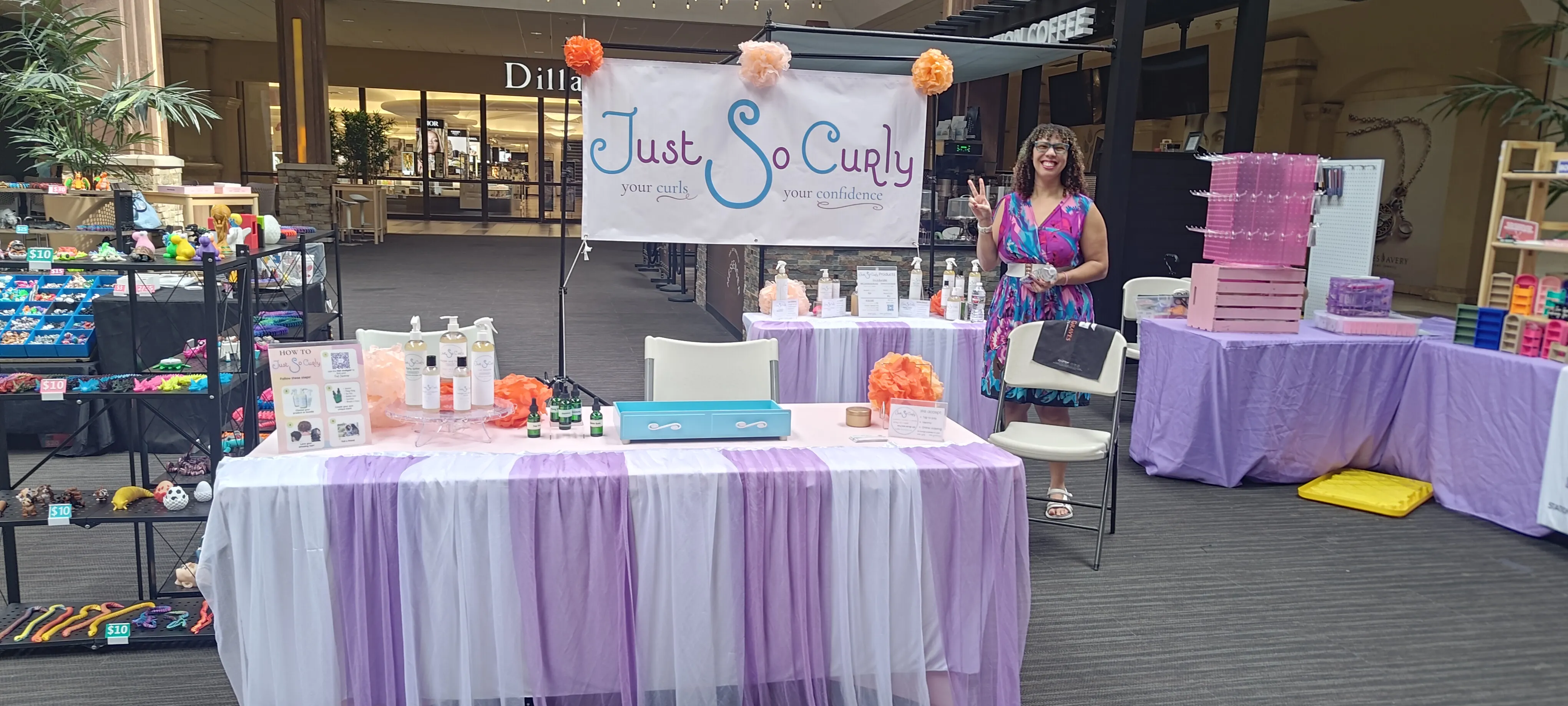 Cassandra setting up the Just So Curly table at the Oak Park Mall pop-up