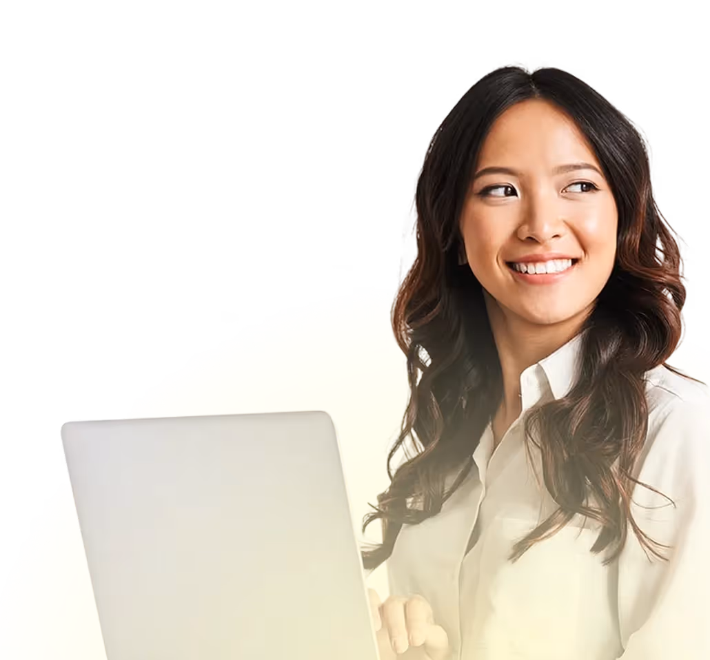 Smiling woman with long wavy hair holding a laptop and looking to the side against a light yellow background.