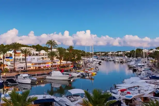 an image of cala dor marina in the day time