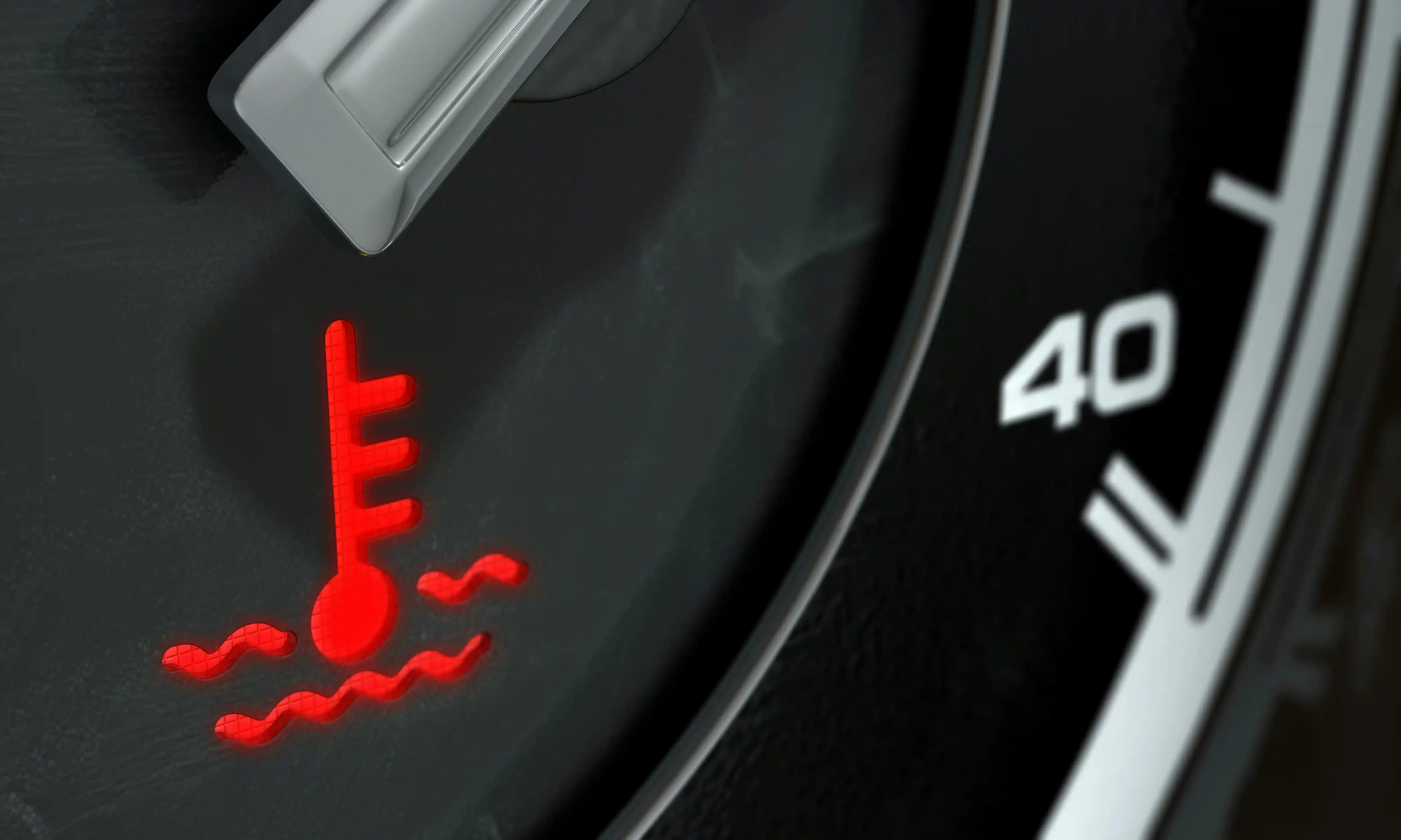 Engine temperature warning light on a car dashboard