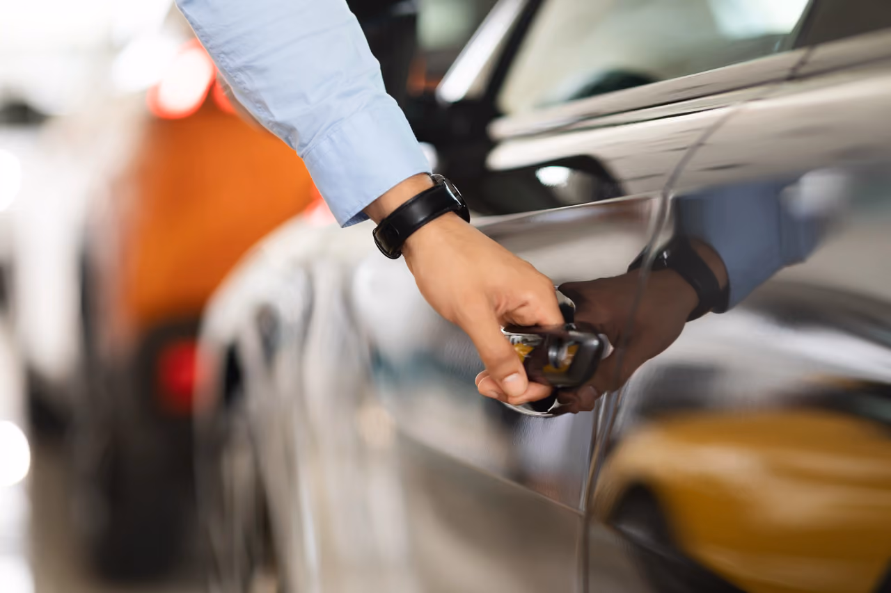 Buyer checking a car door during a used car pre-purchase inspection