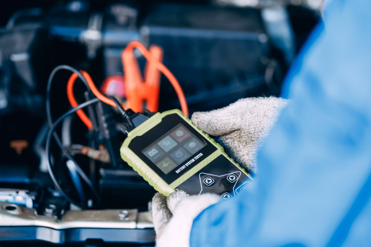 OBD diagnostic scanner connected to a car during a mobile diagnostic check