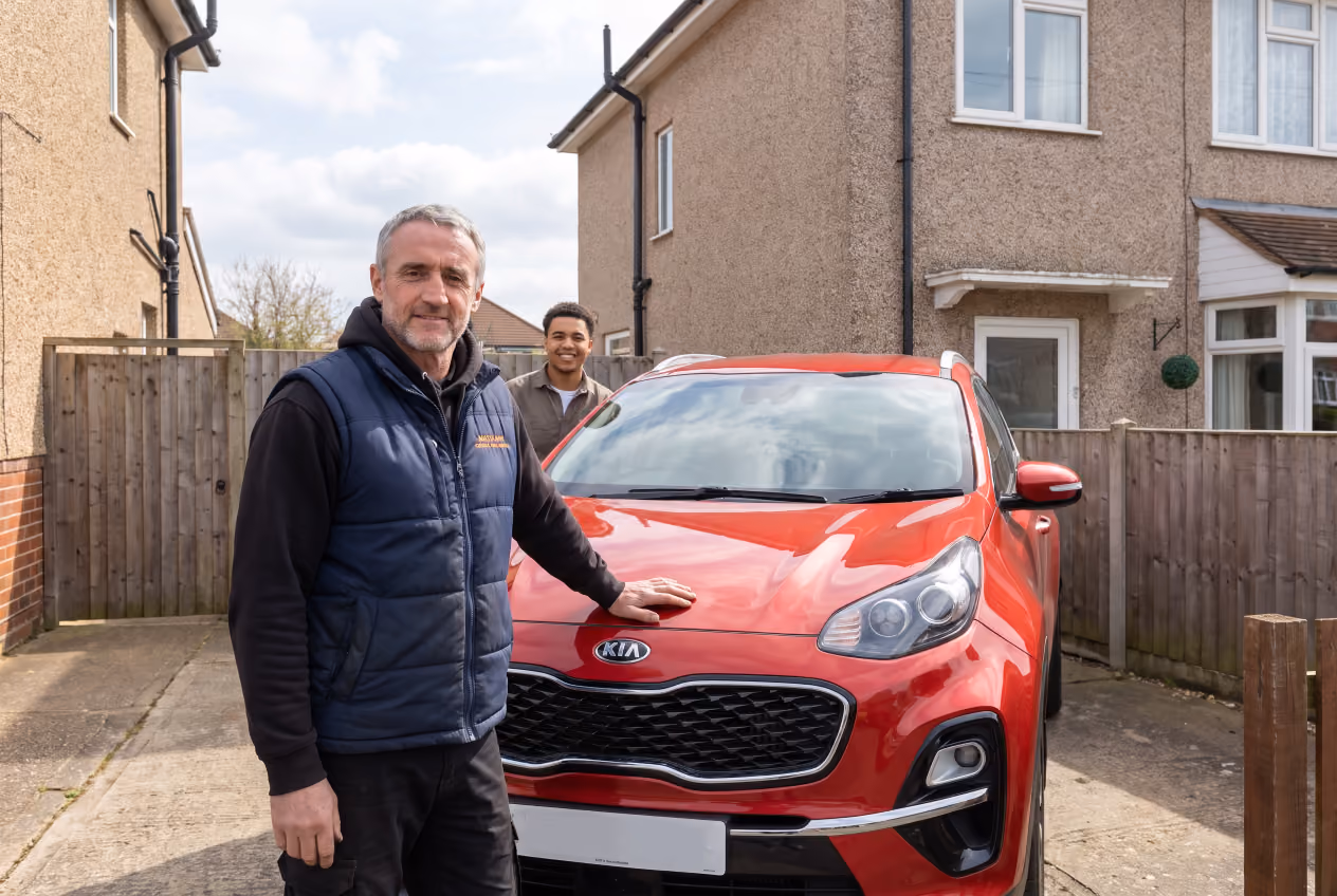 Maxamy mechanic with a customer's red Kia Sportage after a mobile car service
