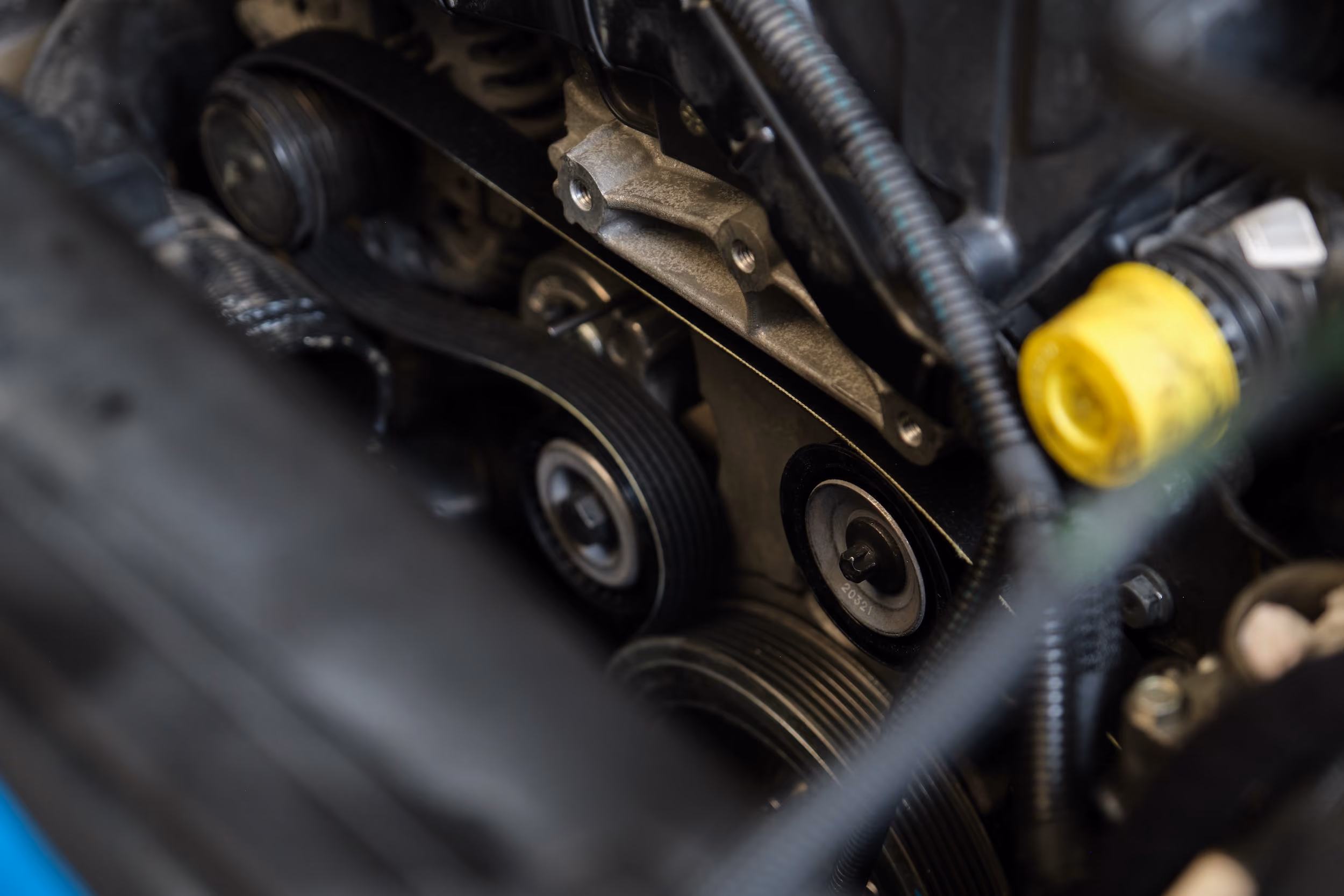 Close-up of engine drive belts and pulleys