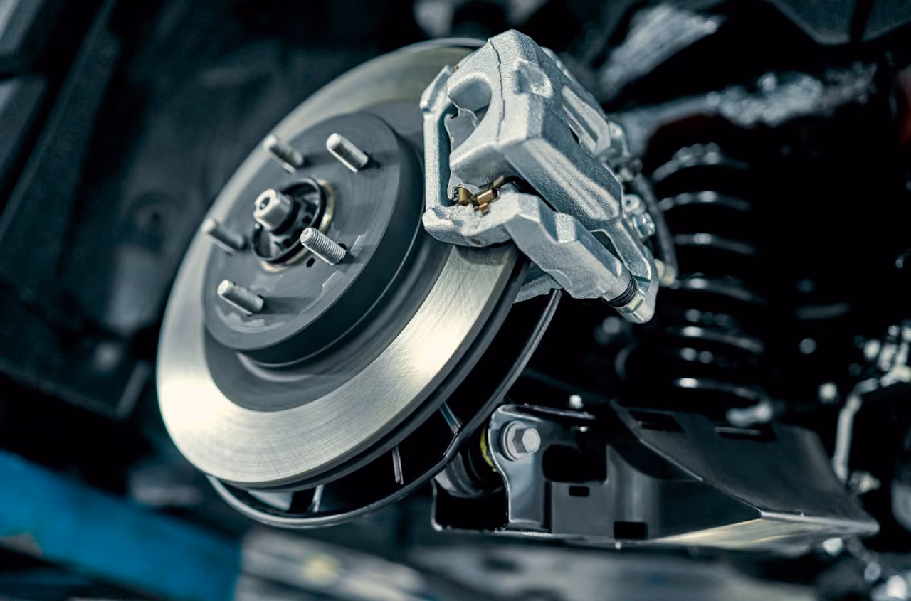 Brake disc and caliper being replaced during a mobile brake repair