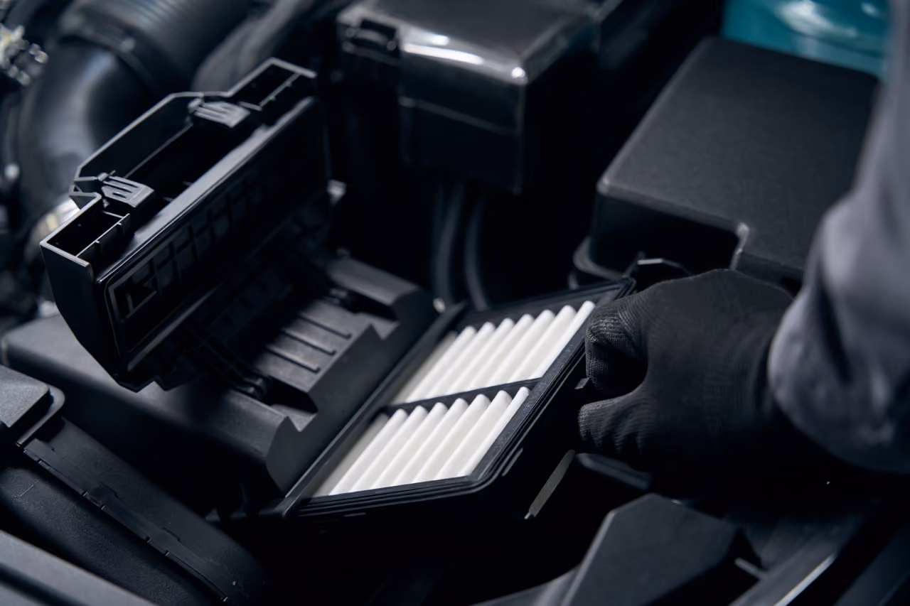 Mechanic replacing the air filter during a full car service