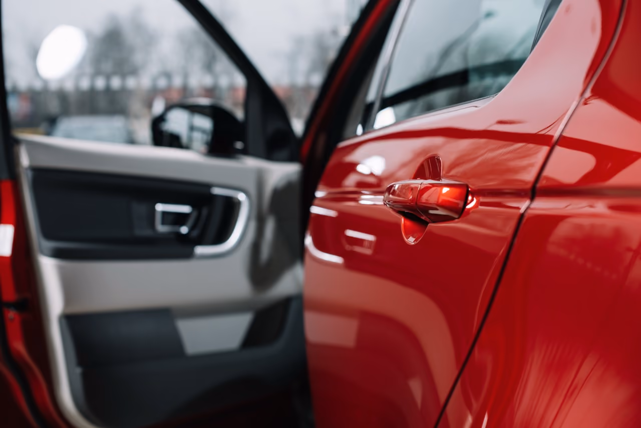 Red car door and interior panel checked during a standard pre-purchase inspection
