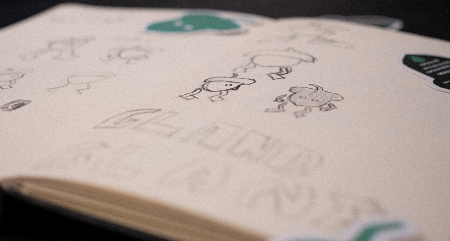Carnet ouvert avec croquis de petits personnages au trait et stickers verts.
