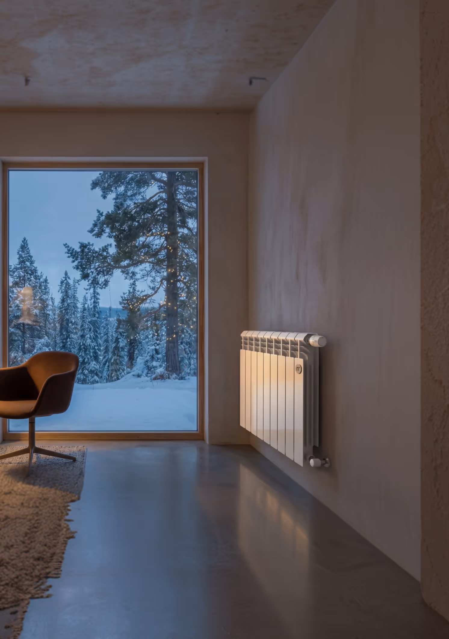 Modern room with a brown chair, lighted wall radiator, and snowy forest visible through large window.