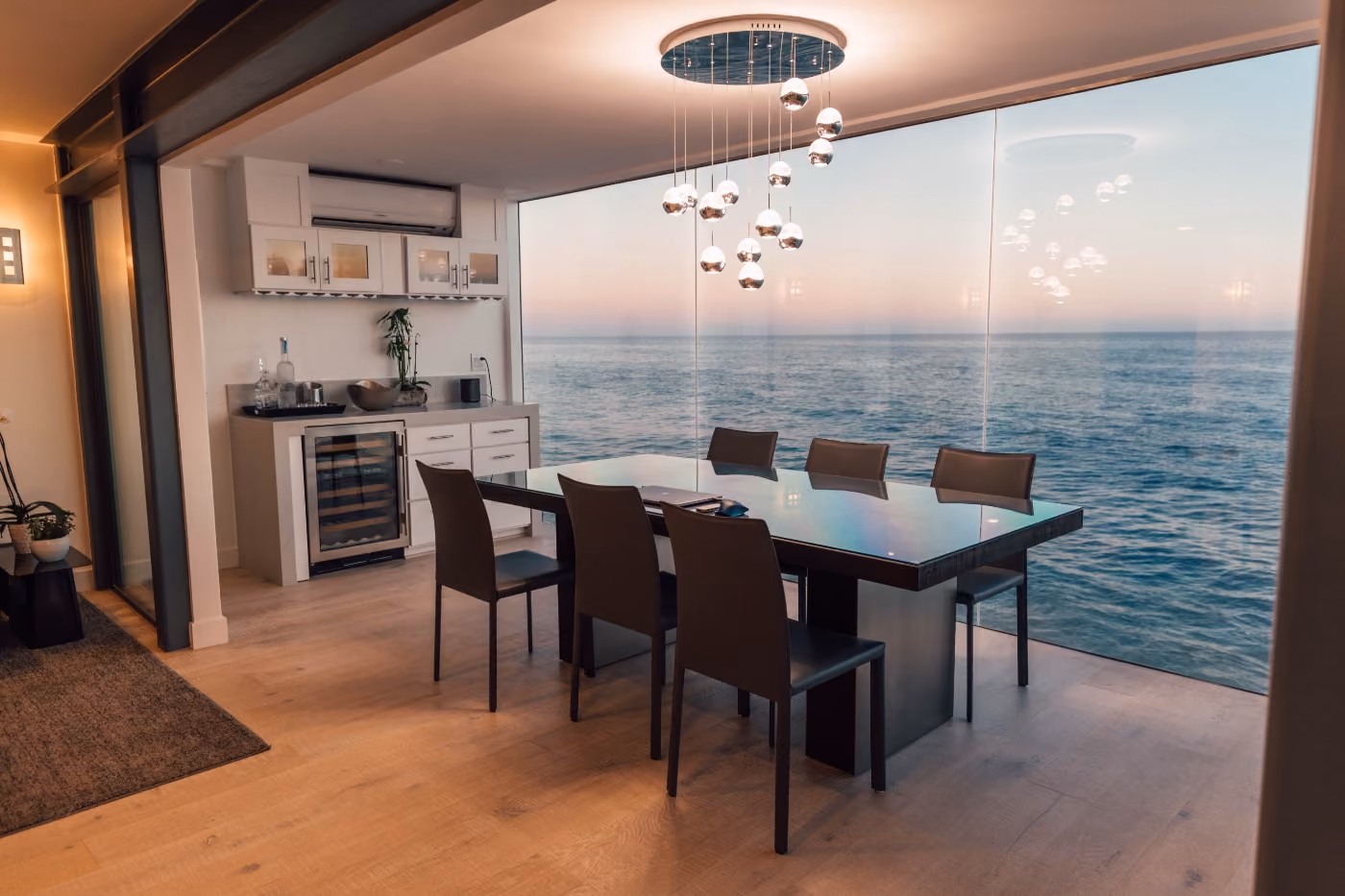 Modern dining room with pendant lights and a sea view