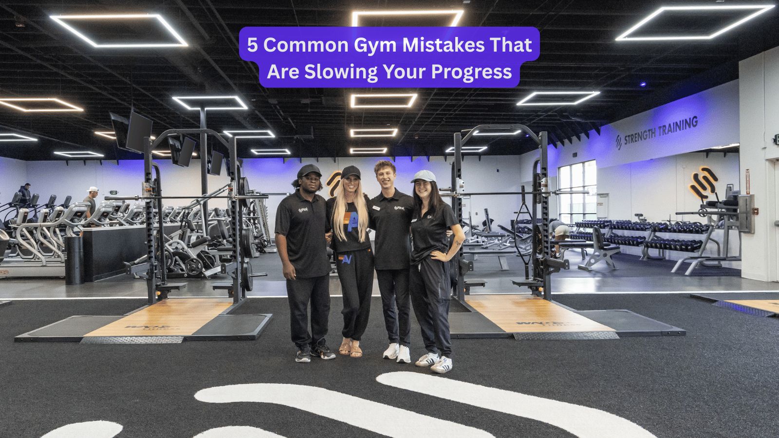 The Fitsi Escondido team standing on the strength training floor in front of the squat racks and dumbbell rack.
