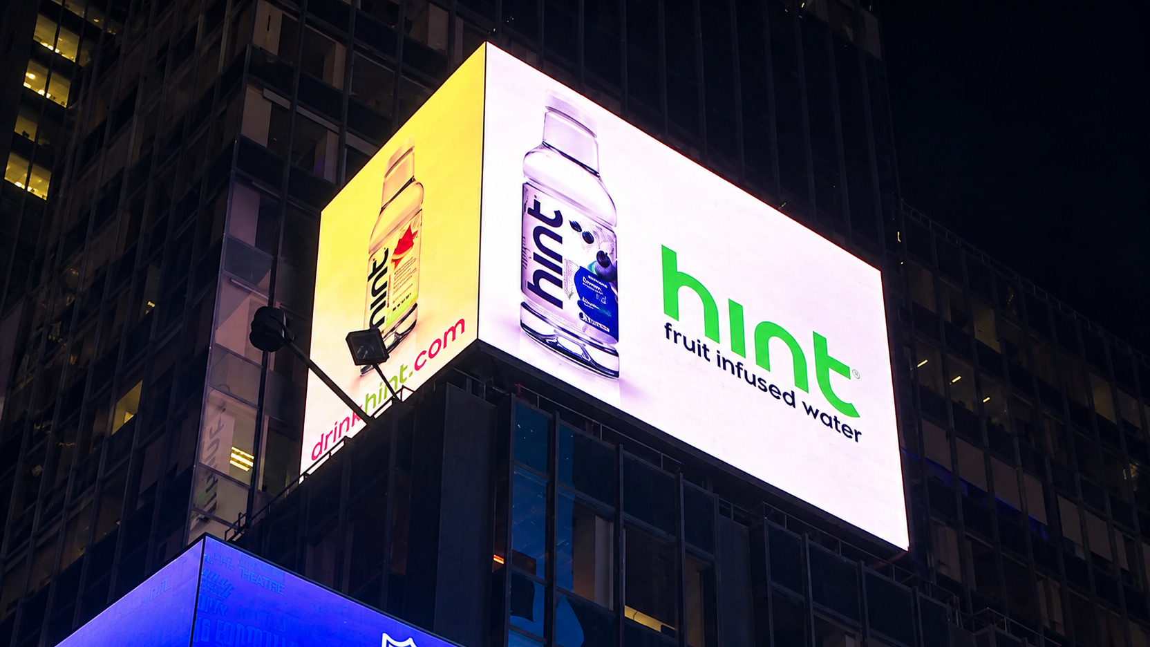 Hint Water wraparound Times Square billboard at night