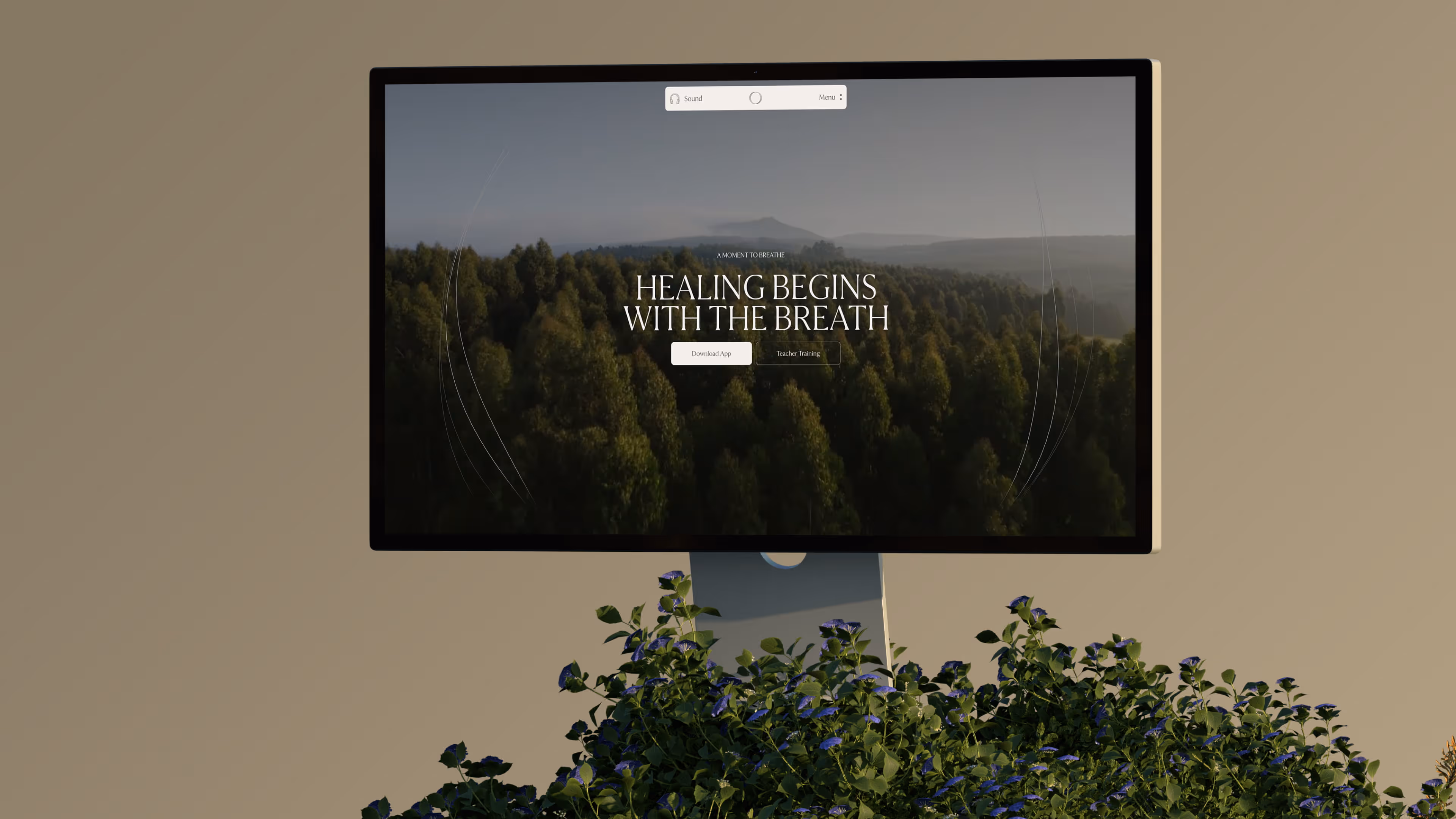 Monitor showing a forest background with text 'Healing begins with the breath' and two buttons below.