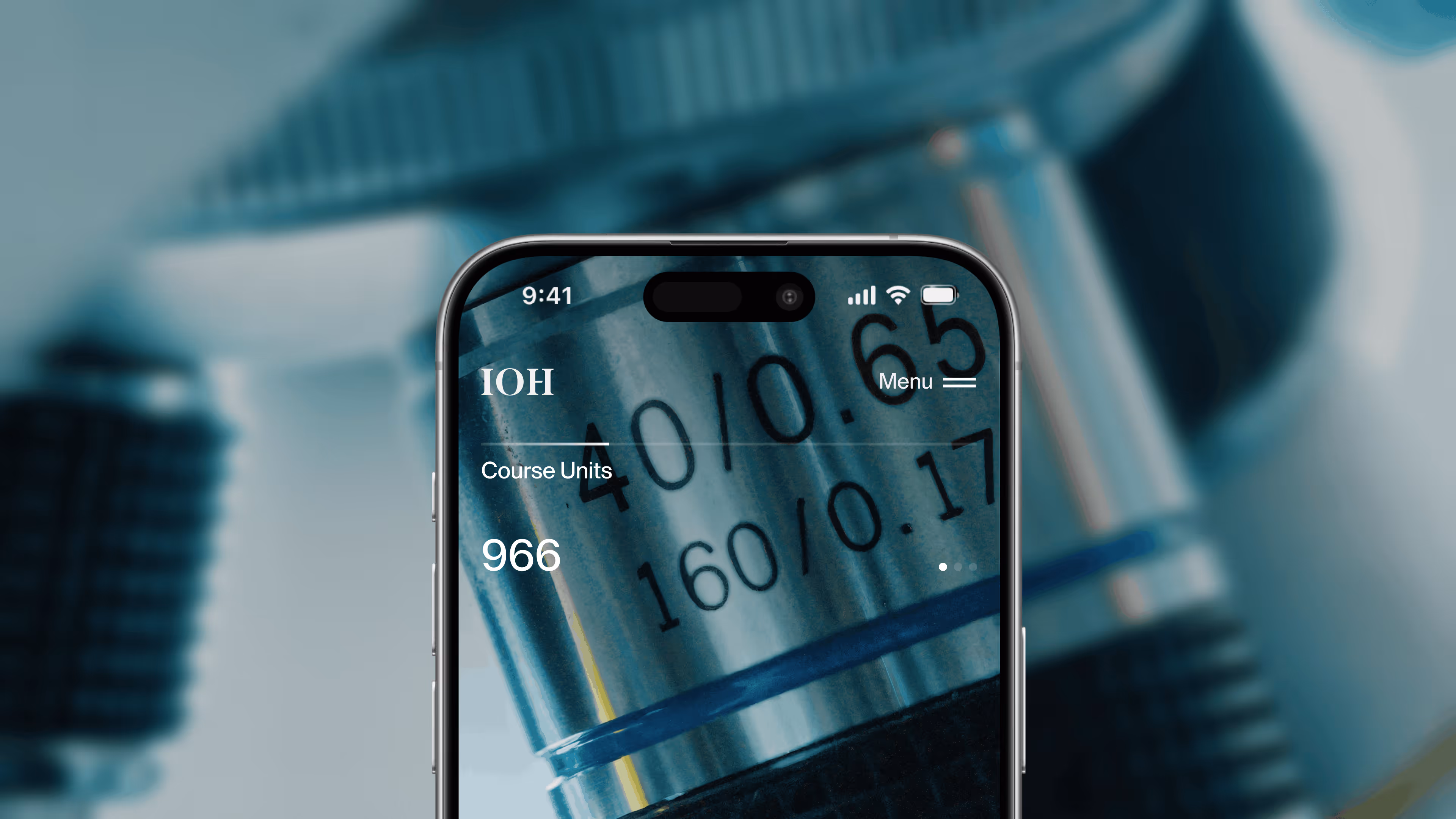 Close-up of a phone screen showing a course units count of 966 with microscope lenses in background.