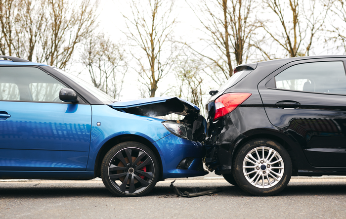 A blue car and a black car with crumpled front-end damage after a collision