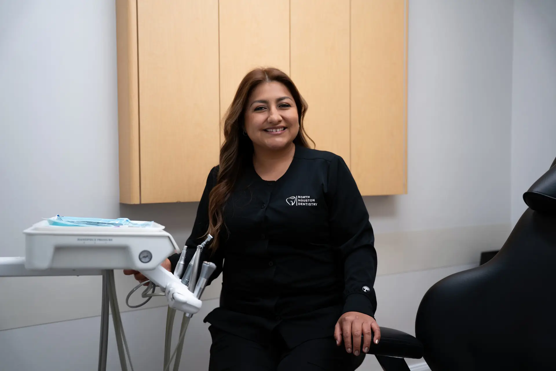 A North Houston Dentistry assistant smiling in the treatment room