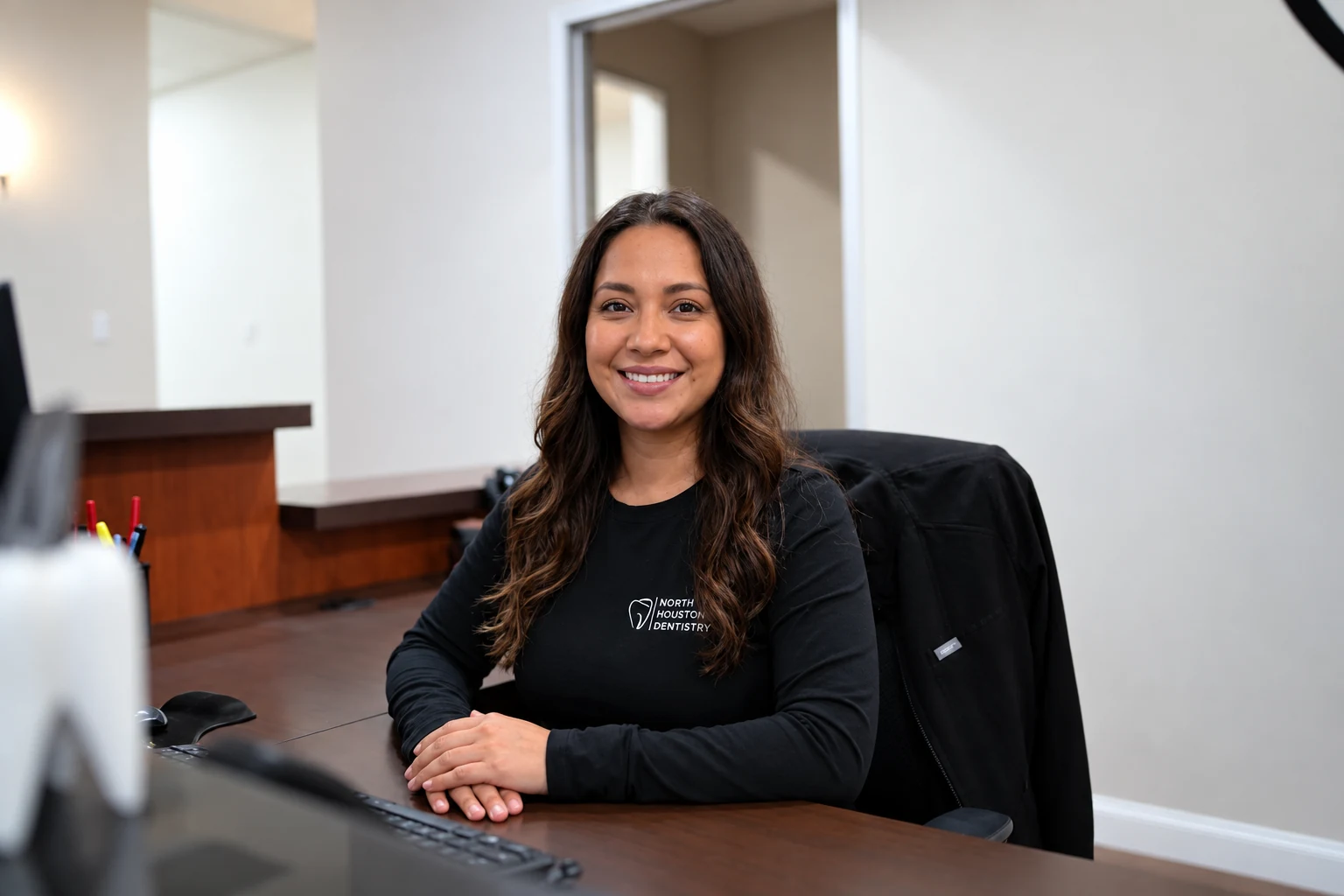 A North Houston Dentistry receptionist smiling at the front desk