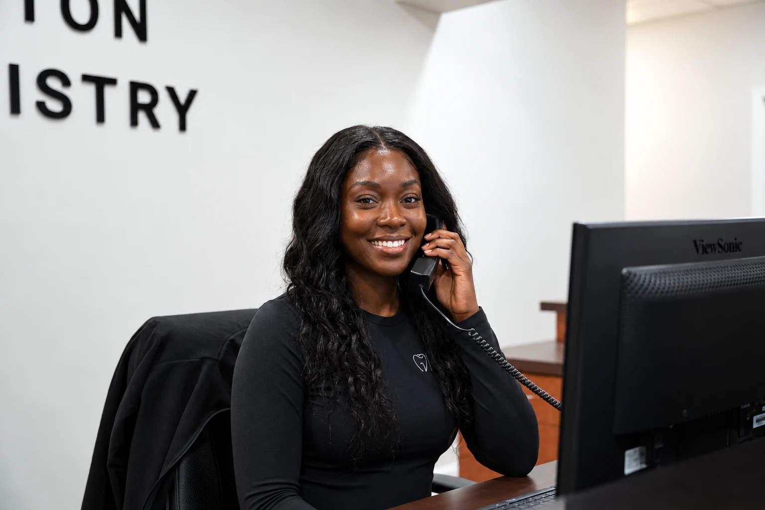 A North Houston Dentistry front desk team member on the phone verifying a patient’s benefits