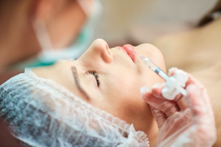 A cosmetician performing cosmetic injections on a woman in Glen Mills, PA, provided by Brandywine Dental Services Group.