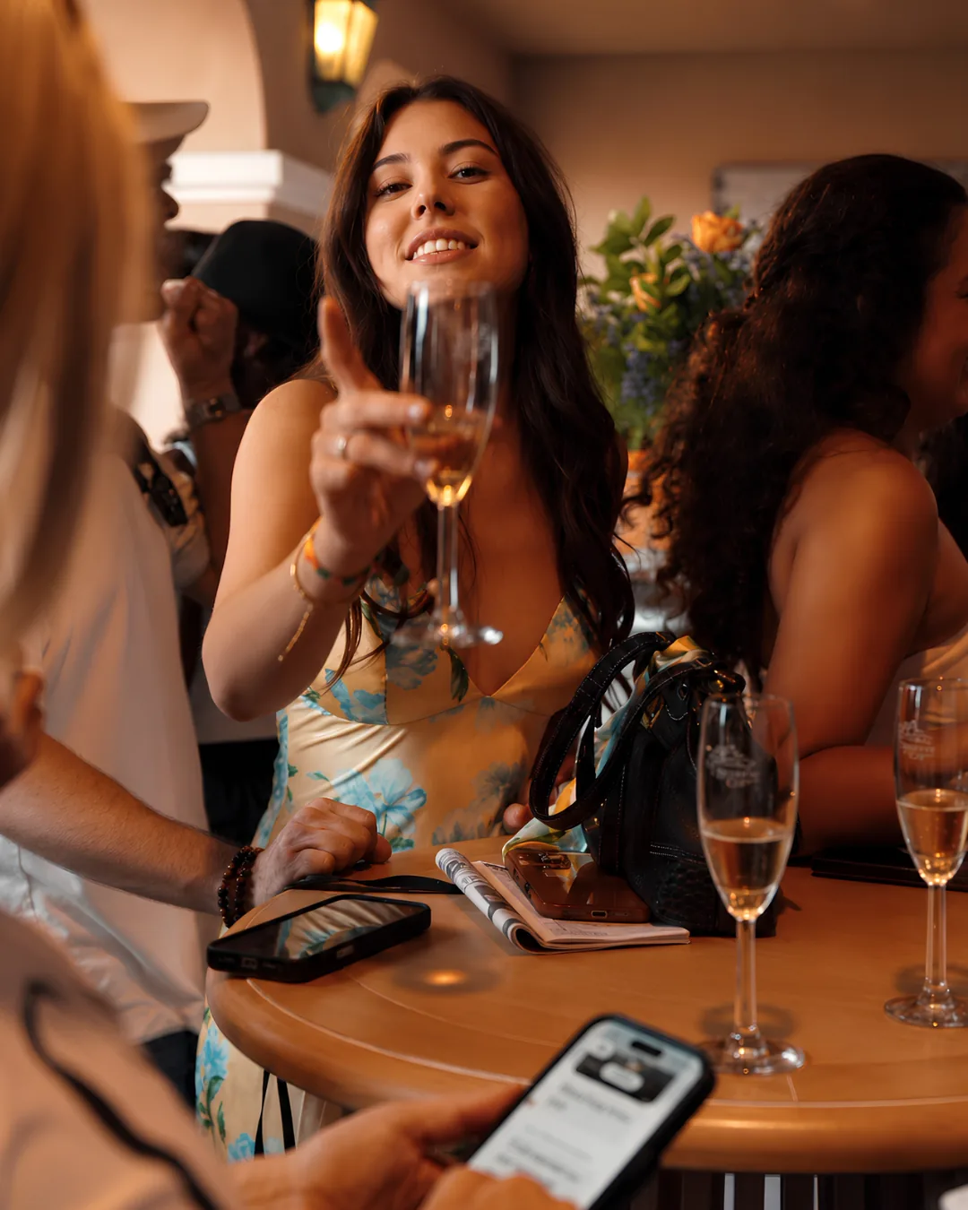 Guests raising champagne in the Champions Room at Del Mar