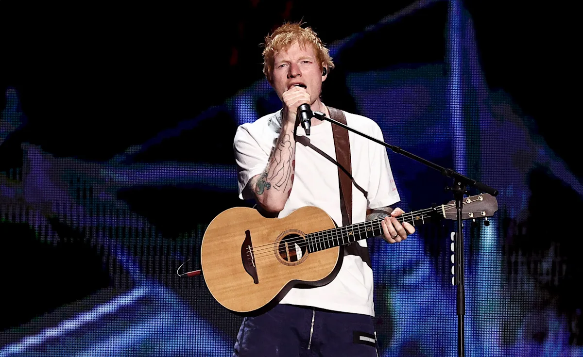Ed Sheeran performing live with an acoustic guitar