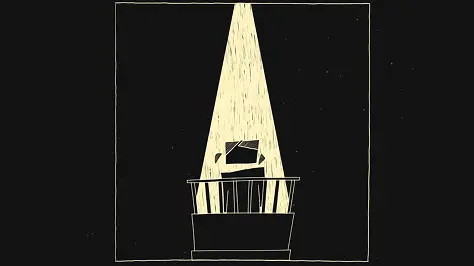 A person standing under a spotlight on a witness stand against a dark background.