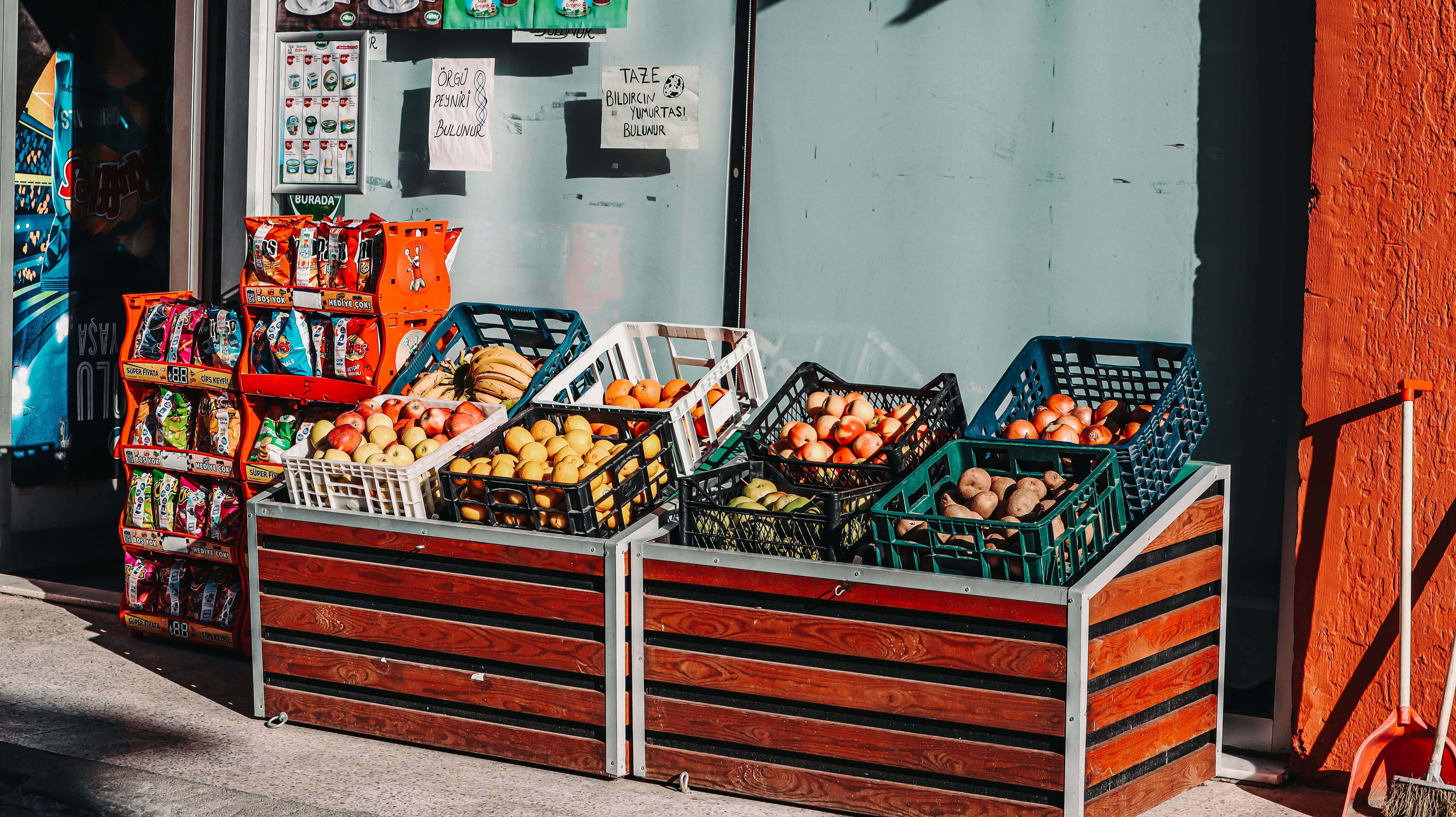 Fresh fruits and vegetables in wooden market crates representing food and beverage cargo industry