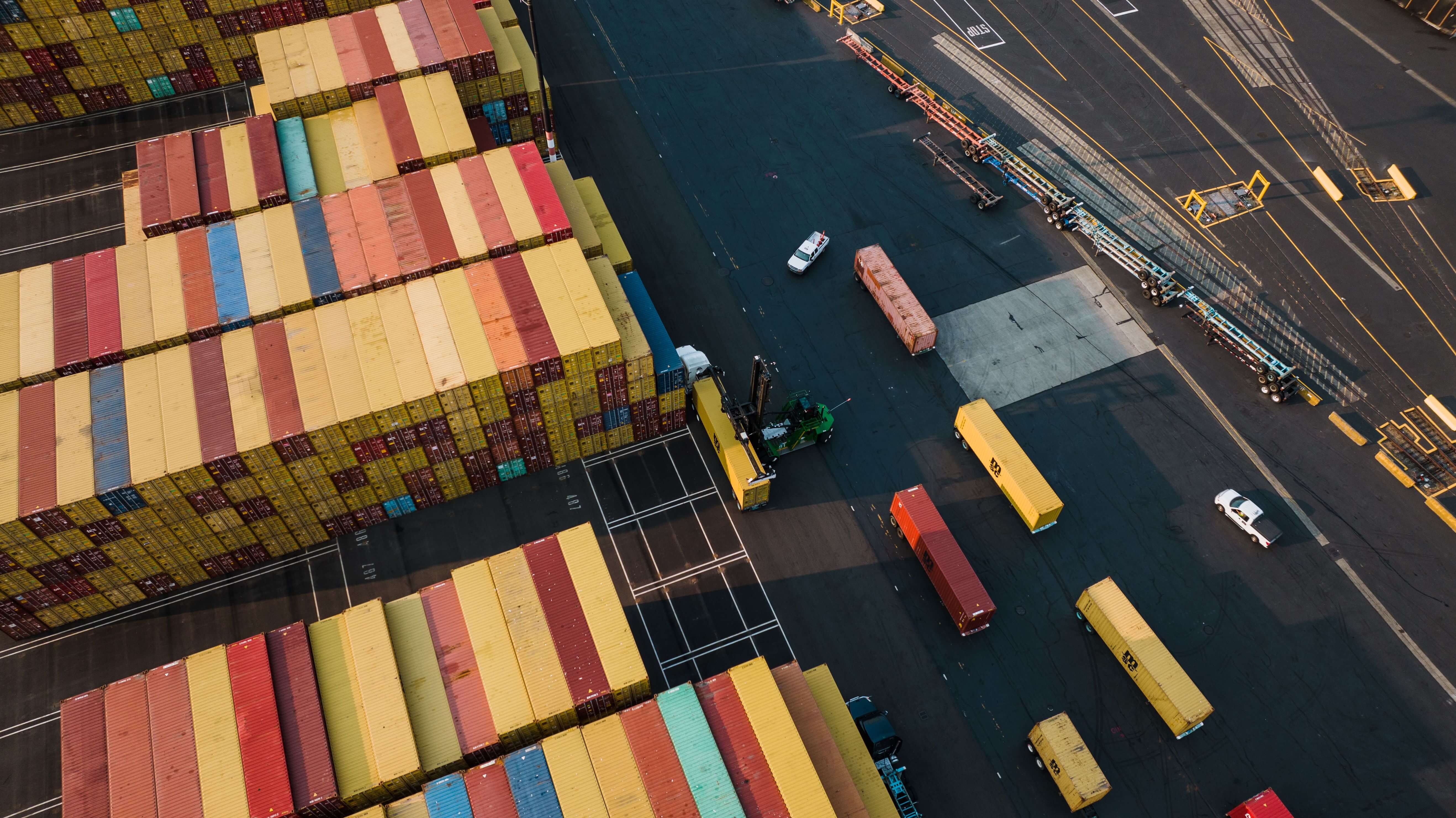 Aerial view of colorful shipping containers stacked at an international cargo port