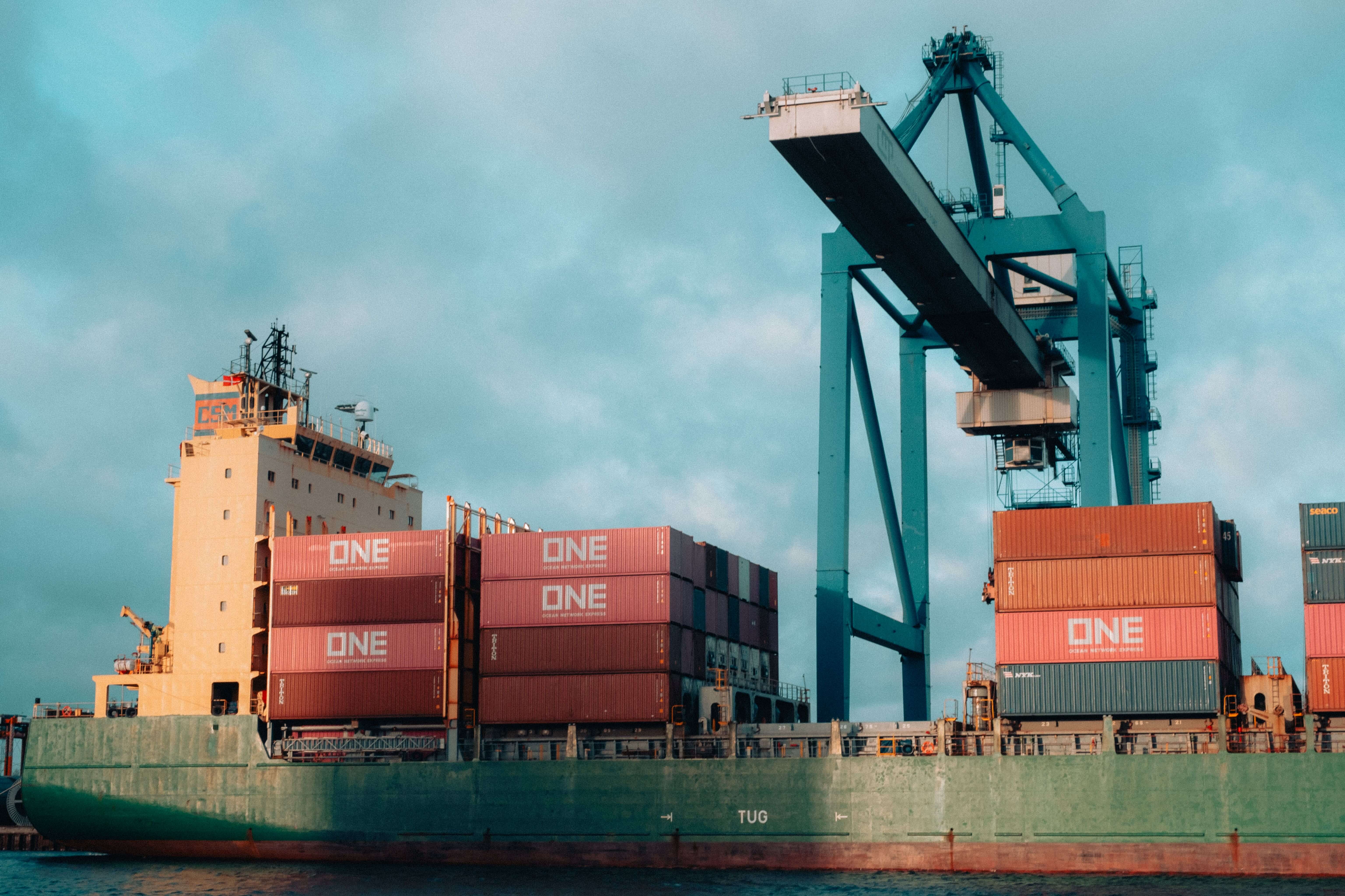 Industrial crane lifting heavy cargo at a port during pre-shipment assessment
