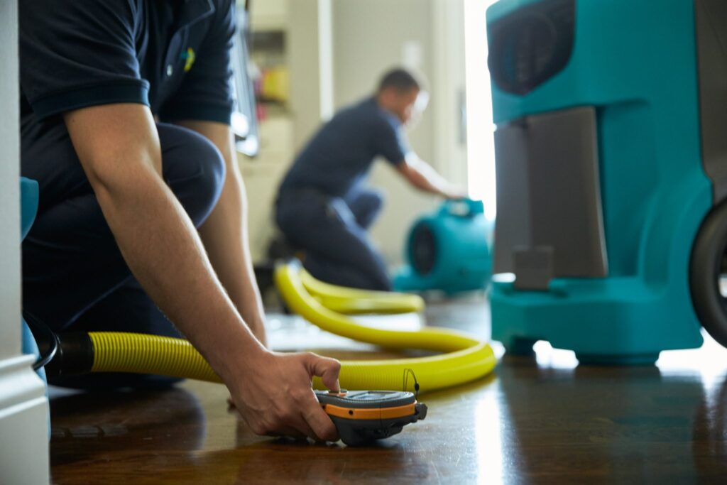 water damage restoration techs with their gear