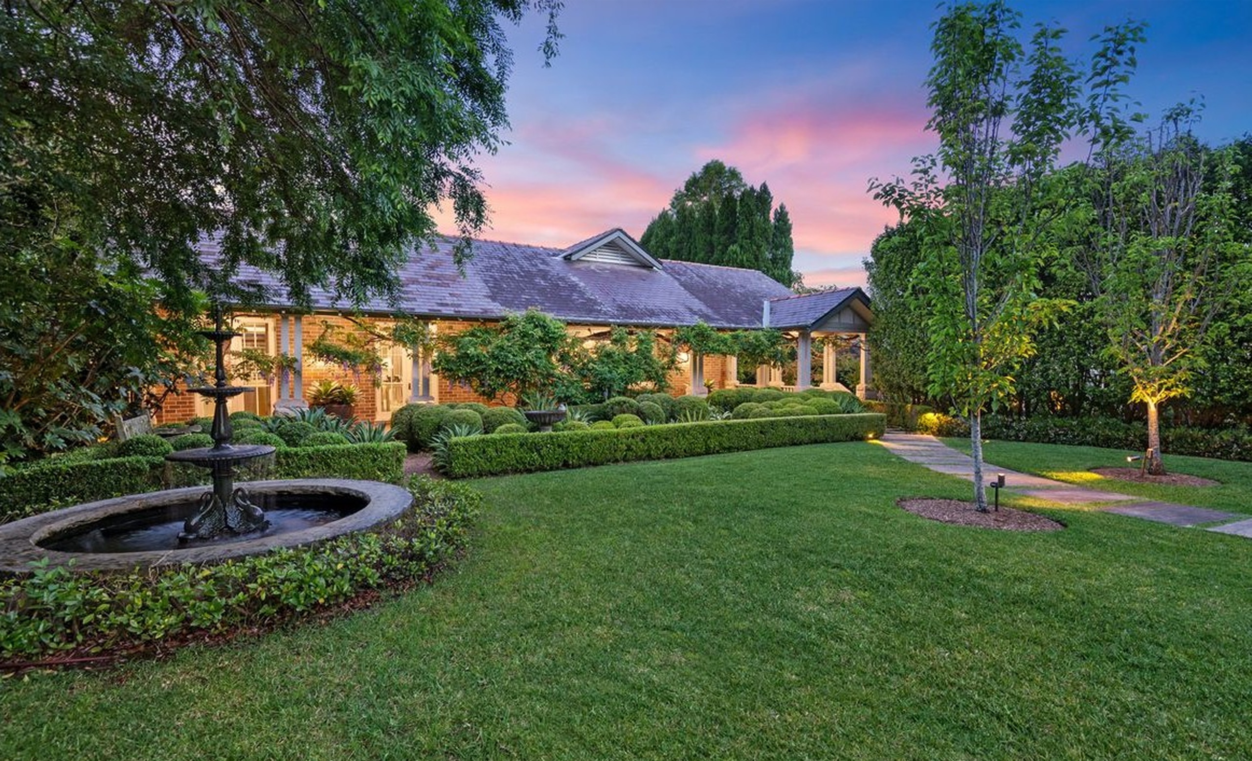 Garden and homestead facade at dusk at Warrangi St, Turramurra by Sydneyside Contracting