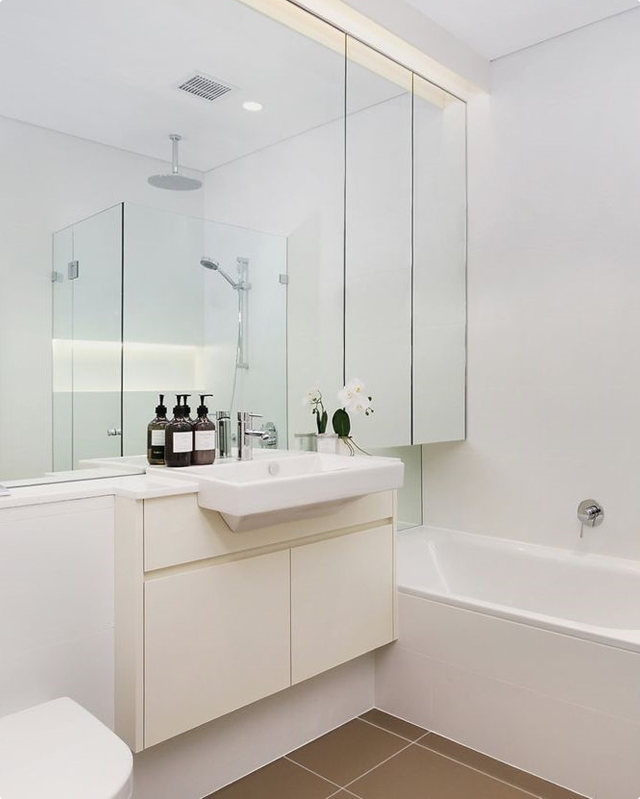 Bathroom with concealed cabinetry at Bourke St, Surry Hills by Sydneyside Contracting