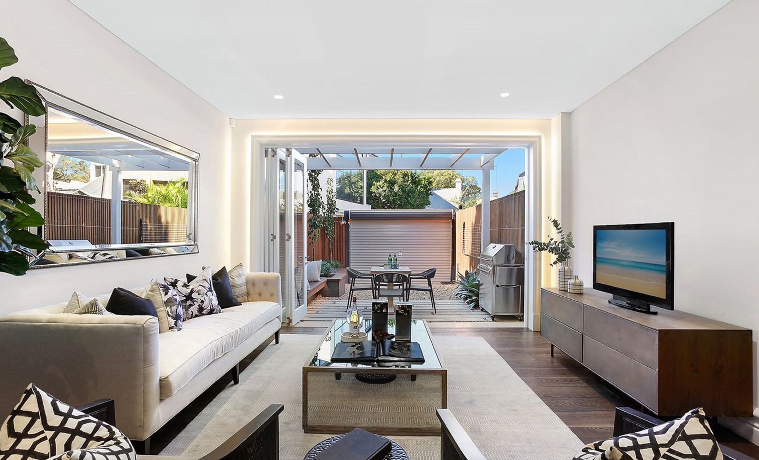 Living room opening to the courtyard at Bourke St, Surry Hills by Sydneyside Contracting