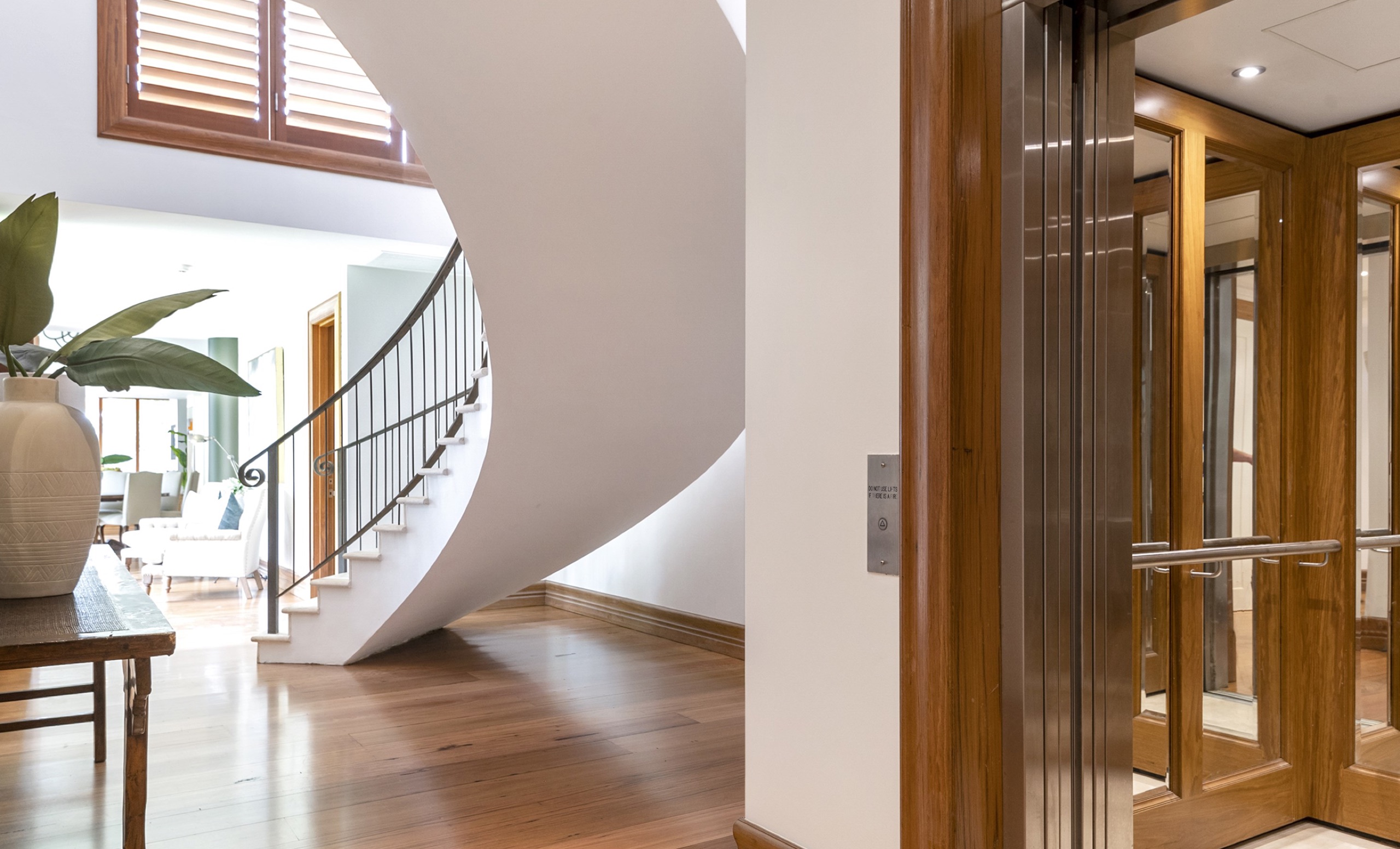 Curved staircase and lift at Ocean Rd, Palm Beach by Sydneyside Contracting