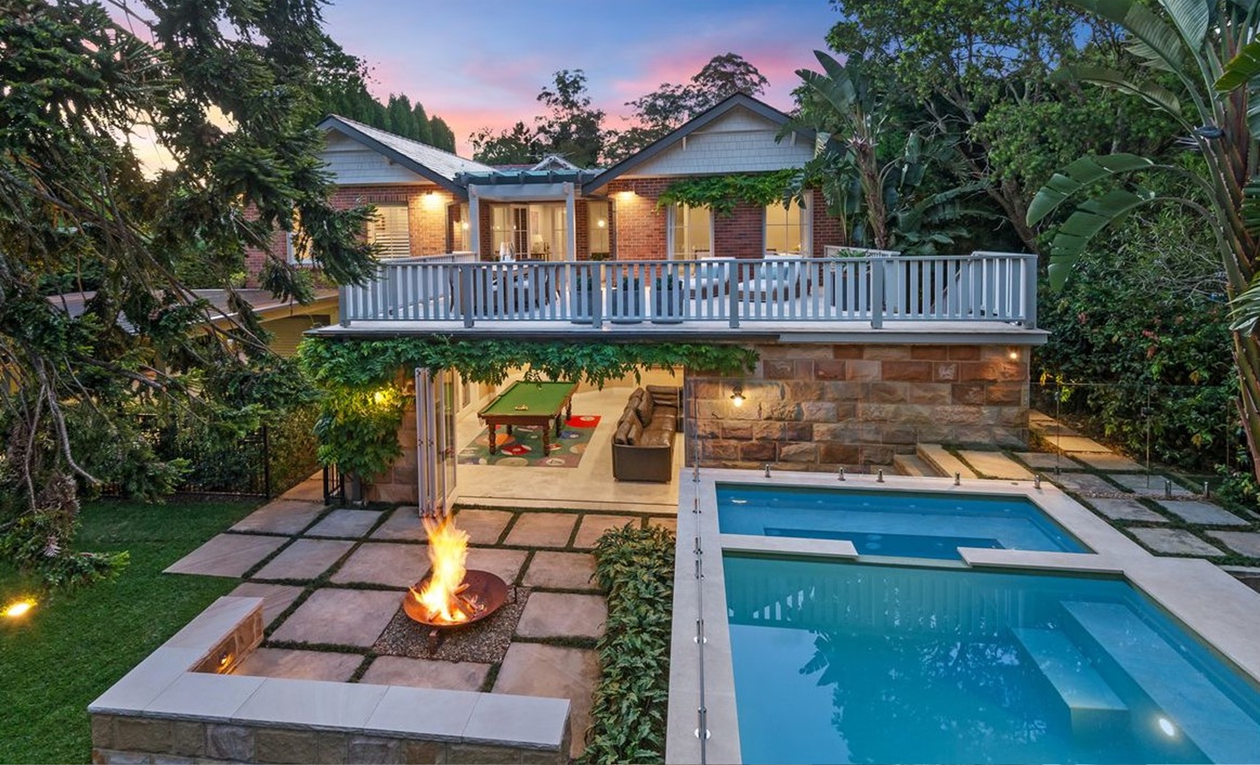 Pool and fire pit at dusk at Warrangi St, Turramurra by Sydneyside Contracting