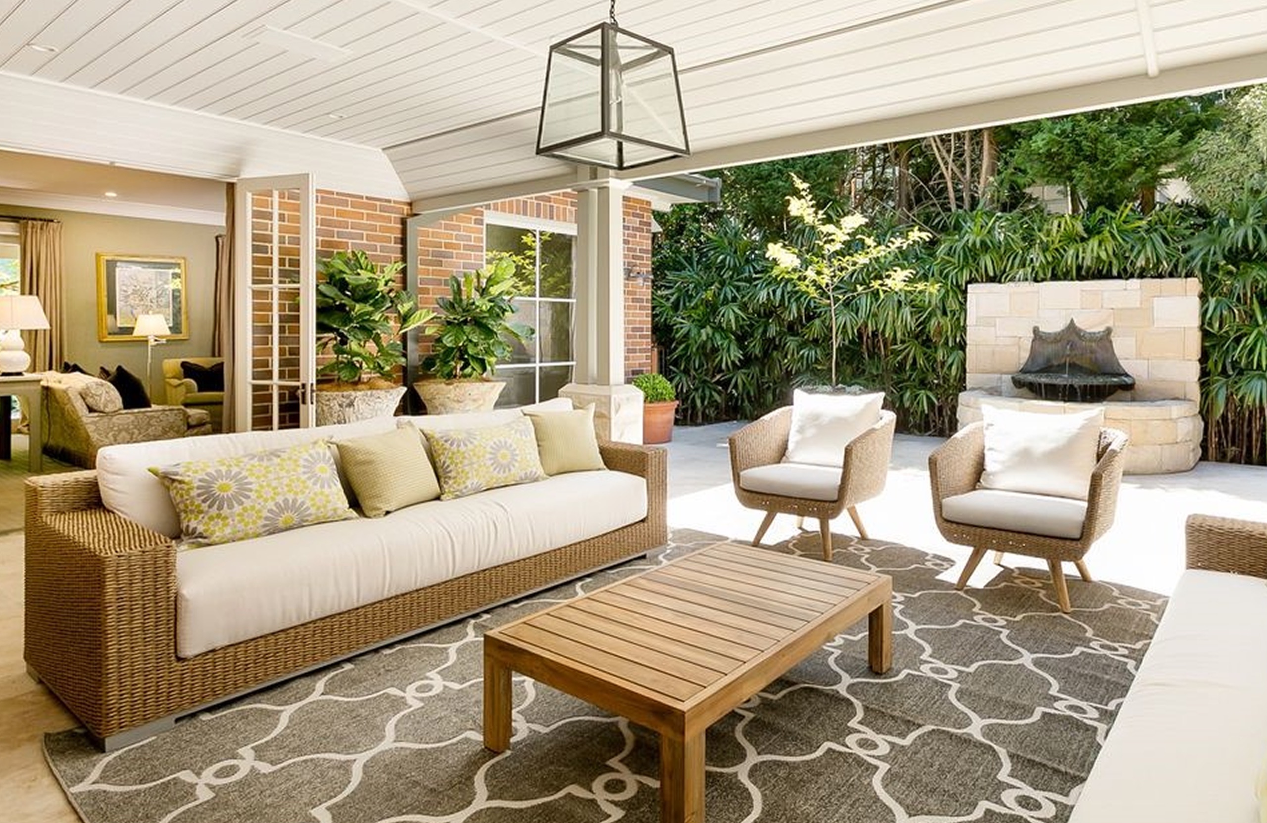Covered terrace lounge with fireplace at Warrangi St, Turramurra by Sydneyside Contracting