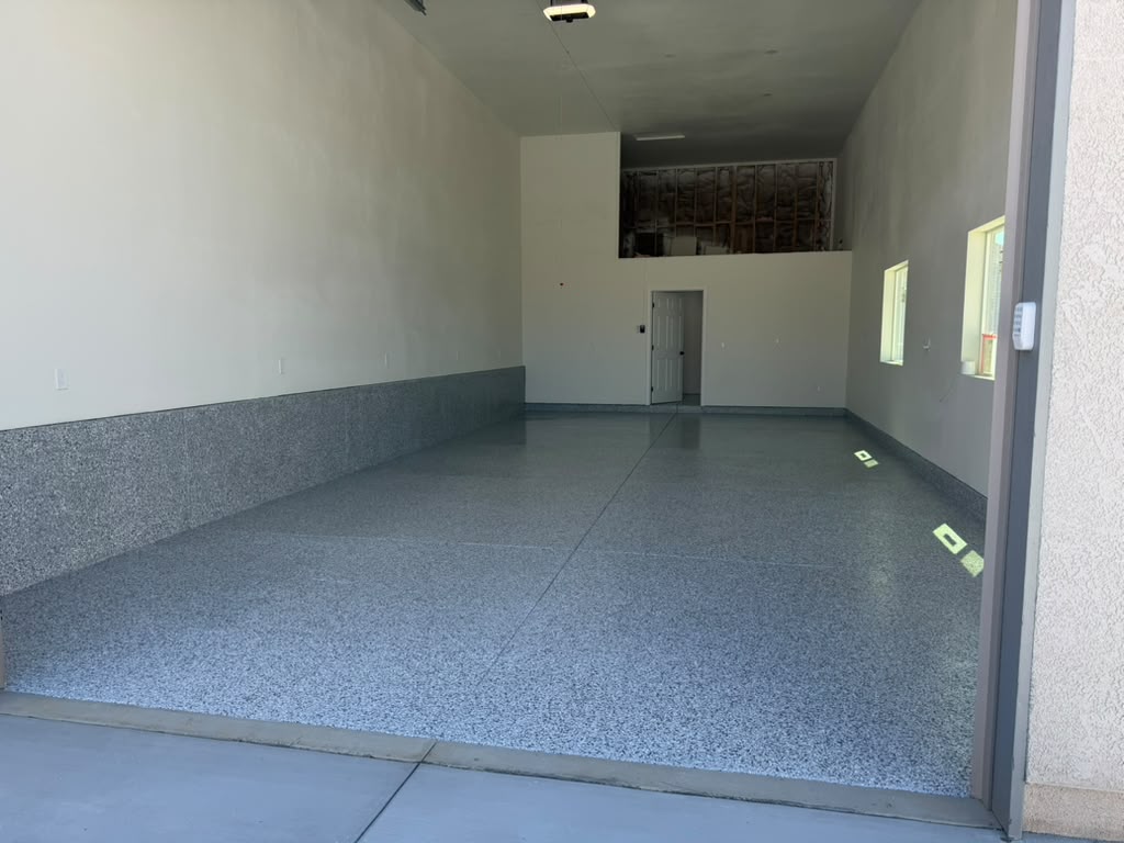 Polyaspartic Gravel flake floor in a 1,000 square foot Yucaipa garage, seen from the roll-up door