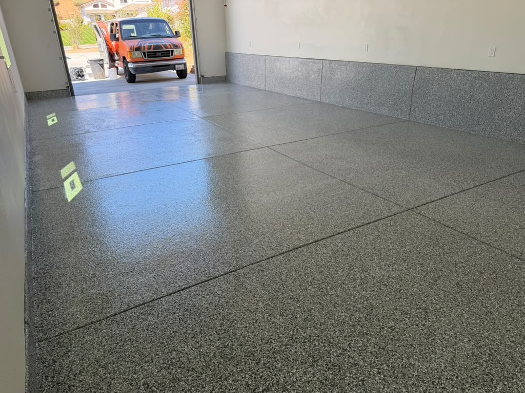 High-gloss Gravel flake garage floor with flake-coated stem walls, looking out to the driveway